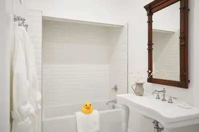 a bathroom with a sink and a tub and a rubber duck at The Kent Collection - The Victorian in Kent