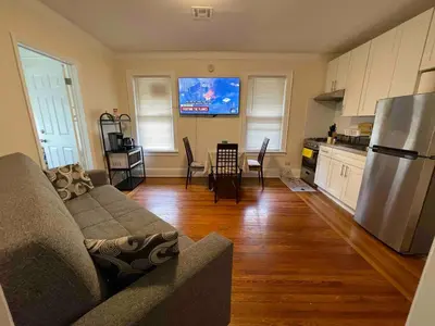 a living room with a couch and a kitchen at Entire Beautiful 2BR Apartment [L]. Convenient location in the heart of Queens! in Whitestone