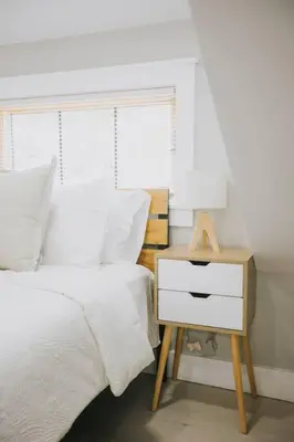 a bedroom with a bed and a nightstand with a white bedspread at Villa Costello, in Kingston