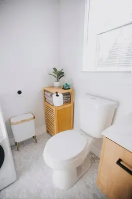 a bathroom with a white toilet and a sink at Villa Costello, in Kingston