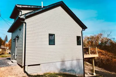 a small white building with a window on it at Villa Costello, in Kingston