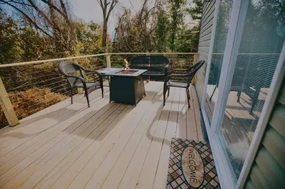 a porch with a table and chairs on a deck at Villa Costello, in Kingston