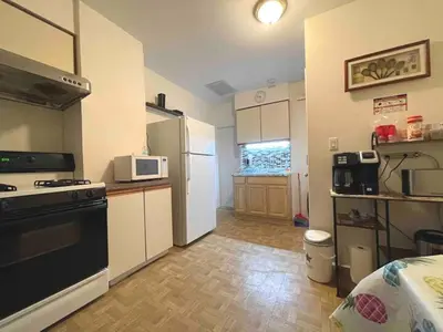 a small kitchen with a stove and a refrigerator at Entire Beautiful 2BR Private Apartment [R] in Whitestone