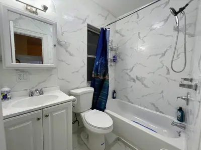 a bathroom with a toilet and a sink and a shower at Entire Beautiful 2BR Private Apartment [R] in Whitestone