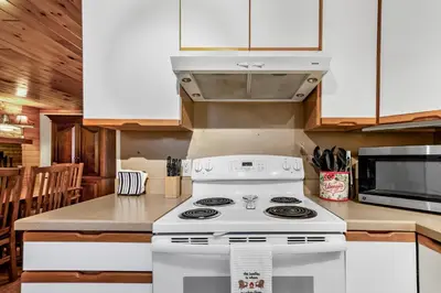 a kitchen with a white stove and a microwave at Lakeview Retreat in Lakeville