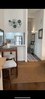 a living room with a table and a kitchen at Unique Place in midtown NYC in New York