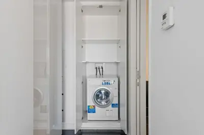 a washer and dryer in a white room at Financial District 1br w WD gym elevator NYC-1368 in New York