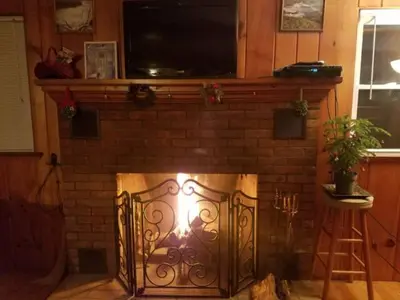 a fireplace with a television on top of it at Tory Hill in Hillsdale