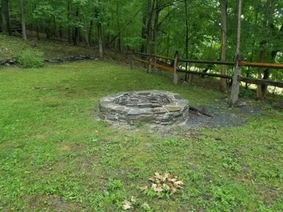 a fire pit in the middle of a field at Tory Hill in Hillsdale