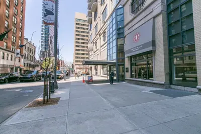 a city street with buildings and a person walking on the sidewalk at Midtown 1br w doorman wd nr Times Square NYC-1351 in New York