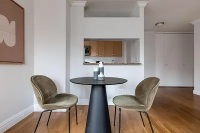 a dining room with a table and two chairs at Midtown 1br w doorman wd nr Times Square NYC-1351 in New York