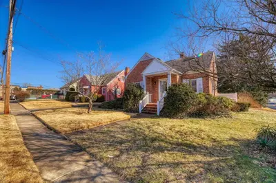 a brick house with a sidewalk in front of it at Family Home near NY Beach - Private Workspace in Glen Head