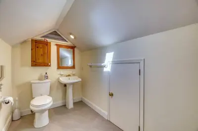 a bathroom with a toilet and a sink at Family Home near NY Beach - Private Workspace in Glen Head