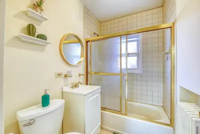 a bathroom with a toilet and a shower and a sink at Family Home near NY Beach - Private Workspace in Glen Head
