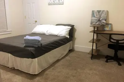 a bedroom with a bed and a desk and a table at Comfy 4 Bed 1 Bath with Wi-fi in College Area in Springfield