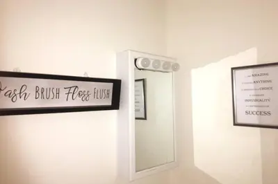 a mirror in a room with a sign on the wall at Comfy 4 Bed 1 Bath with Wi-fi in College Area in Springfield