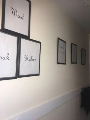a wall with four framed pictures on a wall at Comfy 4 Bed 1 Bath with Wi-fi in College Area in Springfield