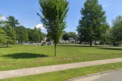 a tree in a park next to a sidewalk at Comfy 4 Bed 1 Bath with Wi-fi in College Area in Springfield