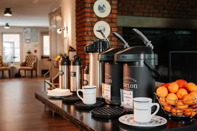 a table with a coffee machine and cups on it at The Ellery in Northampton