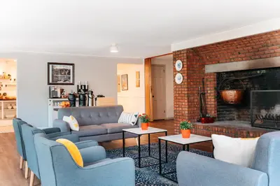 a living room with a couch and a fireplace at The Ellery in Northampton