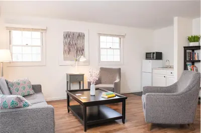 a living room with two chairs and a coffee table at The Ellery in Northampton