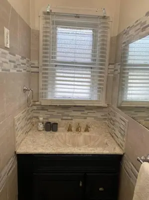 a bathroom with a large sink and a window at Classic King Suite Apartment in Schenectady