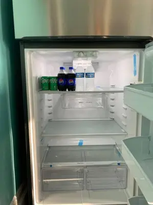 an open refrigerator with bottles of water in it at Classic King Suite Apartment in Schenectady
