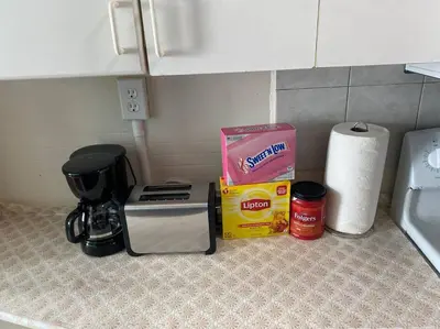 a counter top with a coffee maker and a box on it at Classic King Suite Apartment in Schenectady