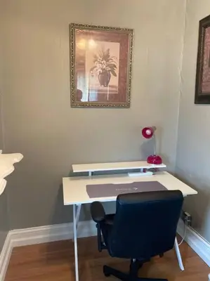 a desk with a chair and a picture on the wall at Classic King Suite Apartment in Schenectady
