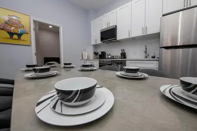 a kitchen with a table with cups and plates on it at Spectacular Times Square 5 Bedroom Duplex Oasis in New York