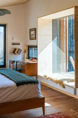 a bedroom with a large window and a desk at Eastwind Hotel Oliverea Valley in Big Indian