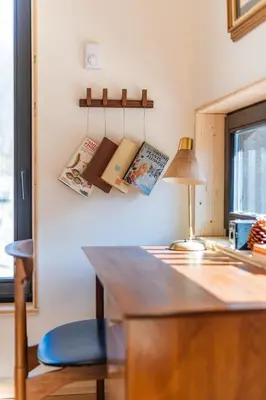 a desk with a lamp and books on a wall at Eastwind Hotel Oliverea Valley in Big Indian