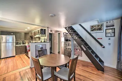 a kitchen with a table and chairs and a staircase at Cozy Milford Cottage on Half Acre w Deck & Grill in Milford