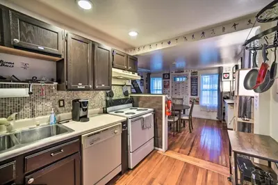 a kitchen with a sink and a stove top oven at Cozy Milford Cottage on Half Acre w Deck & Grill in Milford