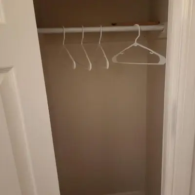 a closet with a white hanger in a room at New York City Guest House in New York