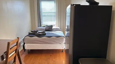 a small bedroom with a bed and a window at New York City Guest House in New York