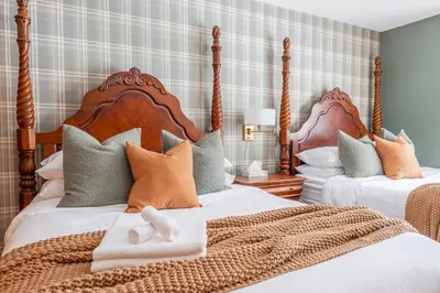 a bedroom with two beds with pillows at 8BR Luxury Maplewood Manor, Hot Tub & Fire Pit in Jewett