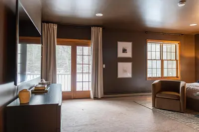 a bedroom with a bed and a desk and a chair at 8BR Luxury Maplewood Manor, Hot Tub & Fire Pit in Jewett