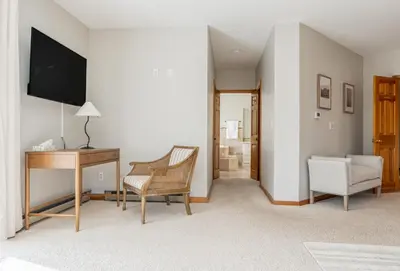 a living room with a desk and a chair at 8BR Luxury Maplewood Manor, Hot Tub & Fire Pit in Jewett