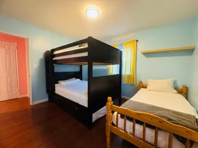 a bedroom with a bunk bed in a room at The Pink Paradise in Bronxdale