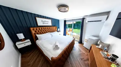 a bedroom with a bed with white sheets and a window at Chalet 239-Boutique Hotel in West Dover
