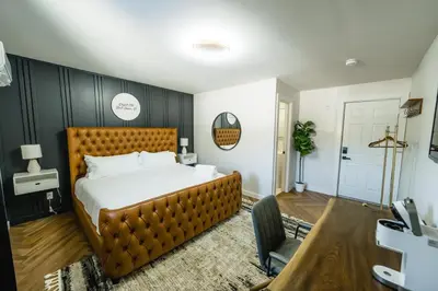 a bedroom with a large bed with a wooden headboard at Chalet 239-Boutique Hotel in West Dover