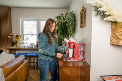 a woman standing at a counter with a coffee maker at Chalet 239-Boutique Hotel in West Dover