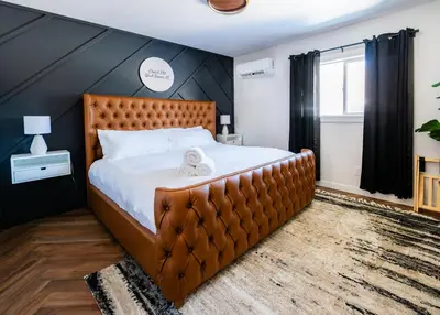 a bedroom with a large bed with a brown headboard at Chalet 239-Boutique Hotel in West Dover