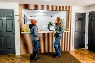 two people standing at a counter in a room at Chalet 239-Boutique Hotel in West Dover