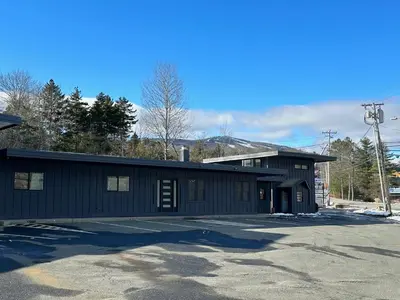 a black building with a parking lot in front of it at Chalet 239-Boutique Hotel in West Dover