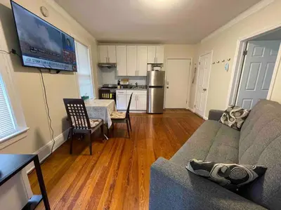 a living room with a couch and a kitchen at Entire Cozy 1BR Apartment in heart of Queens L in Whitestone
