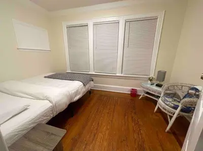 a small bedroom with a bed and a window at Entire Cozy 1BR Apartment in heart of Queens L in Whitestone