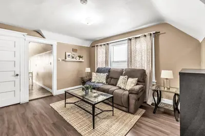 a living room with a couch and a table at Bedroom walking distance to Yale Bridgeport Hospital in Bridgeport
