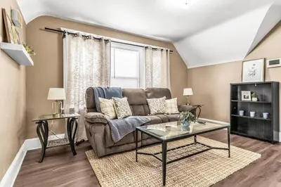 a living room with a couch and a table at Bedroom walking distance to Yale Bridgeport Hospital in Bridgeport